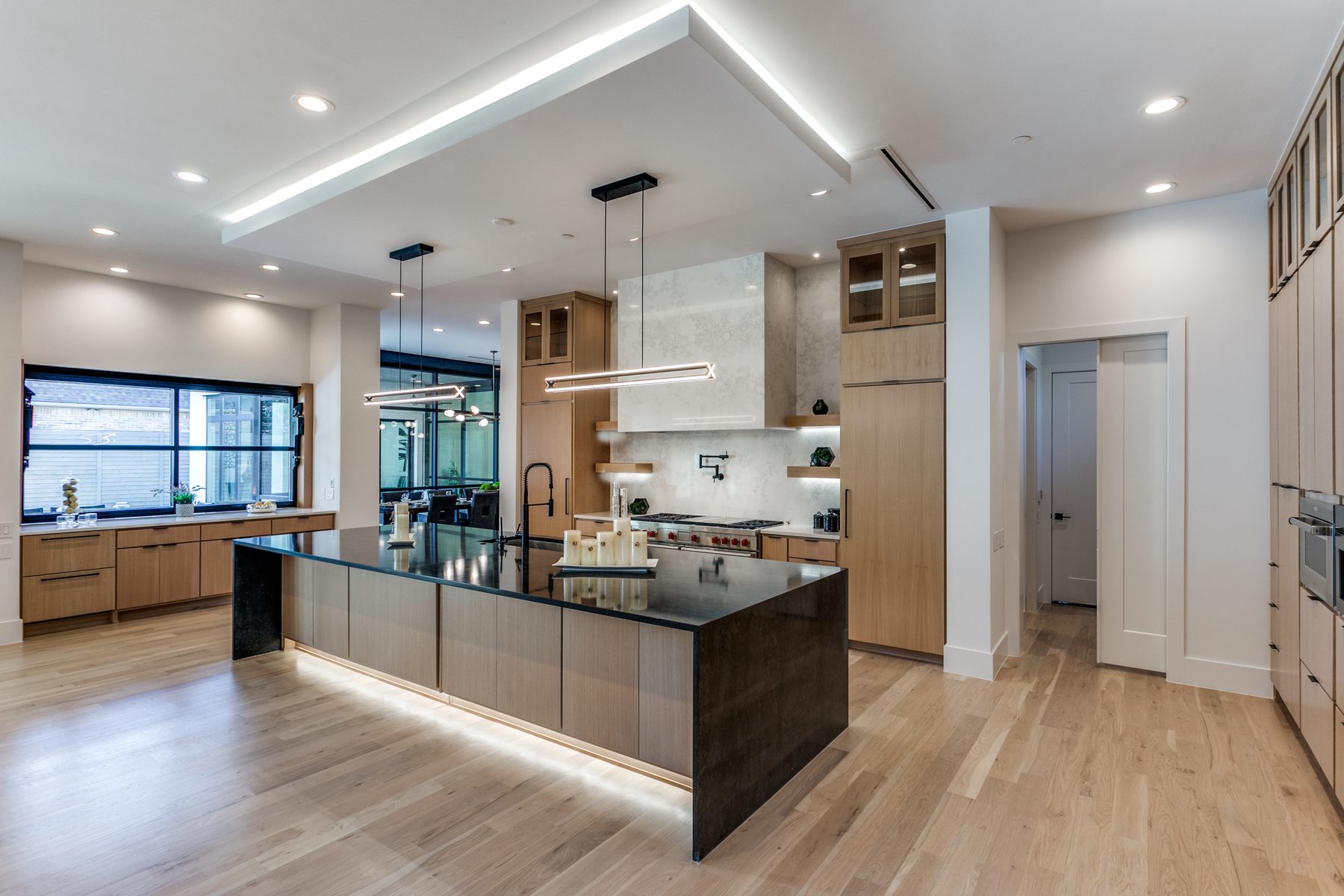 Kitchen with blackened-steel island and cove lighting